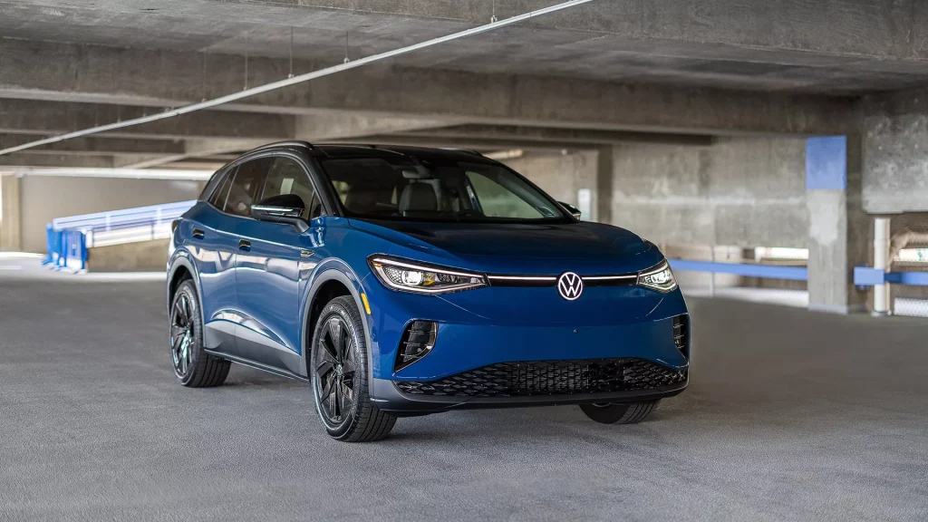 Blue Volkswagen ID.4 electric SUV parked in a concrete parking structure.