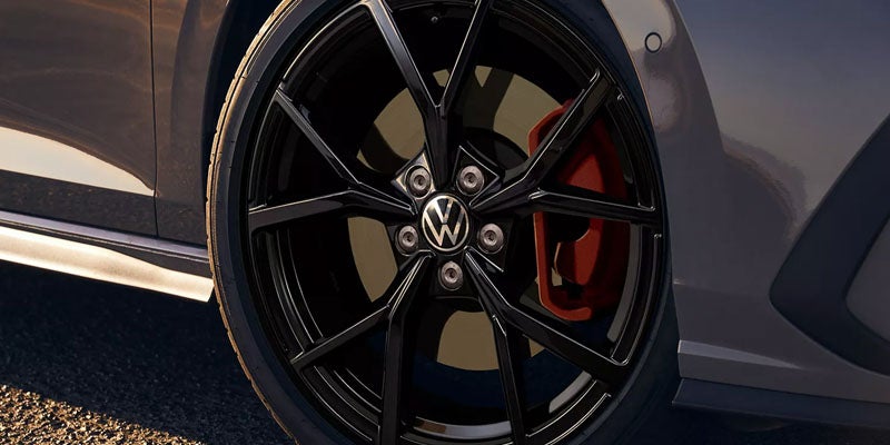 Close-up of a Volkswagen GTI alloy wheel with red brake caliper.