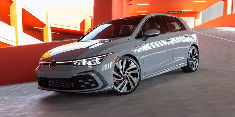 Gray Volkswagen GTI sedan parked in a modern garage.