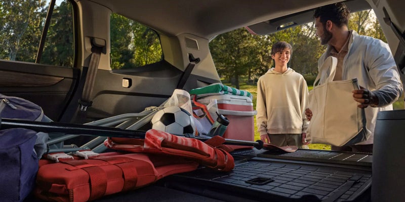 Open cargo area of the 2026 Volkswagen Atlas loaded with gear and luggage.