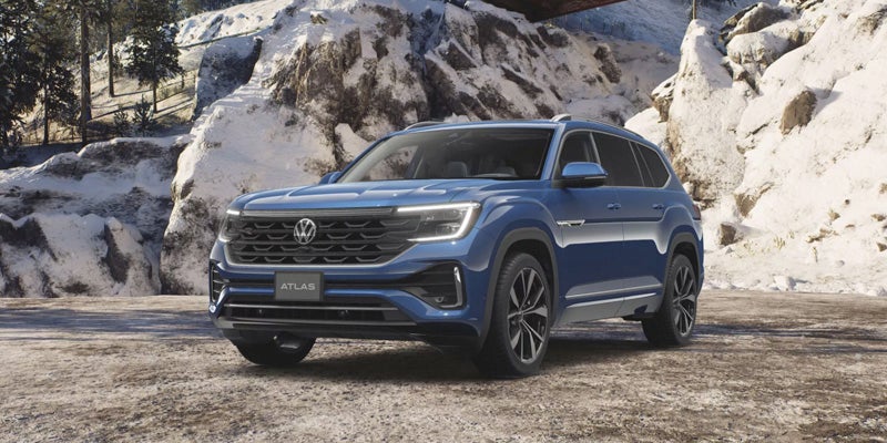 Blue 2026 Volkswagen Atlas parked on a snowy mountain road