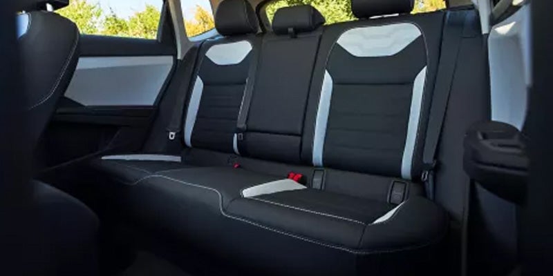 Volkswagen Taos rear seat interior with bench seating and seatbelts.