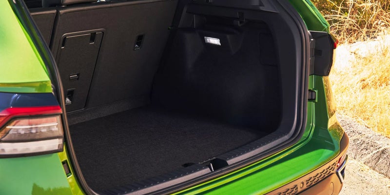 Volkswagen Taos cargo area with rear hatch open and empty trunk space.