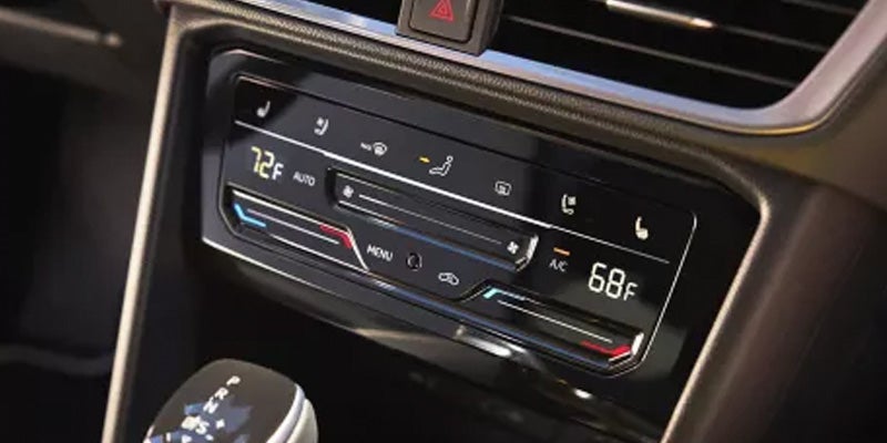 Volkswagen Taos climate control panel showing temperature and AC settings.